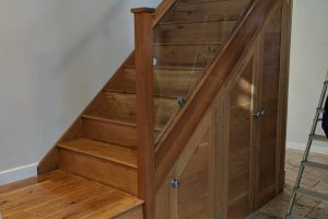 Enhanced wooden staircase with glass panel - eco-friendly design.